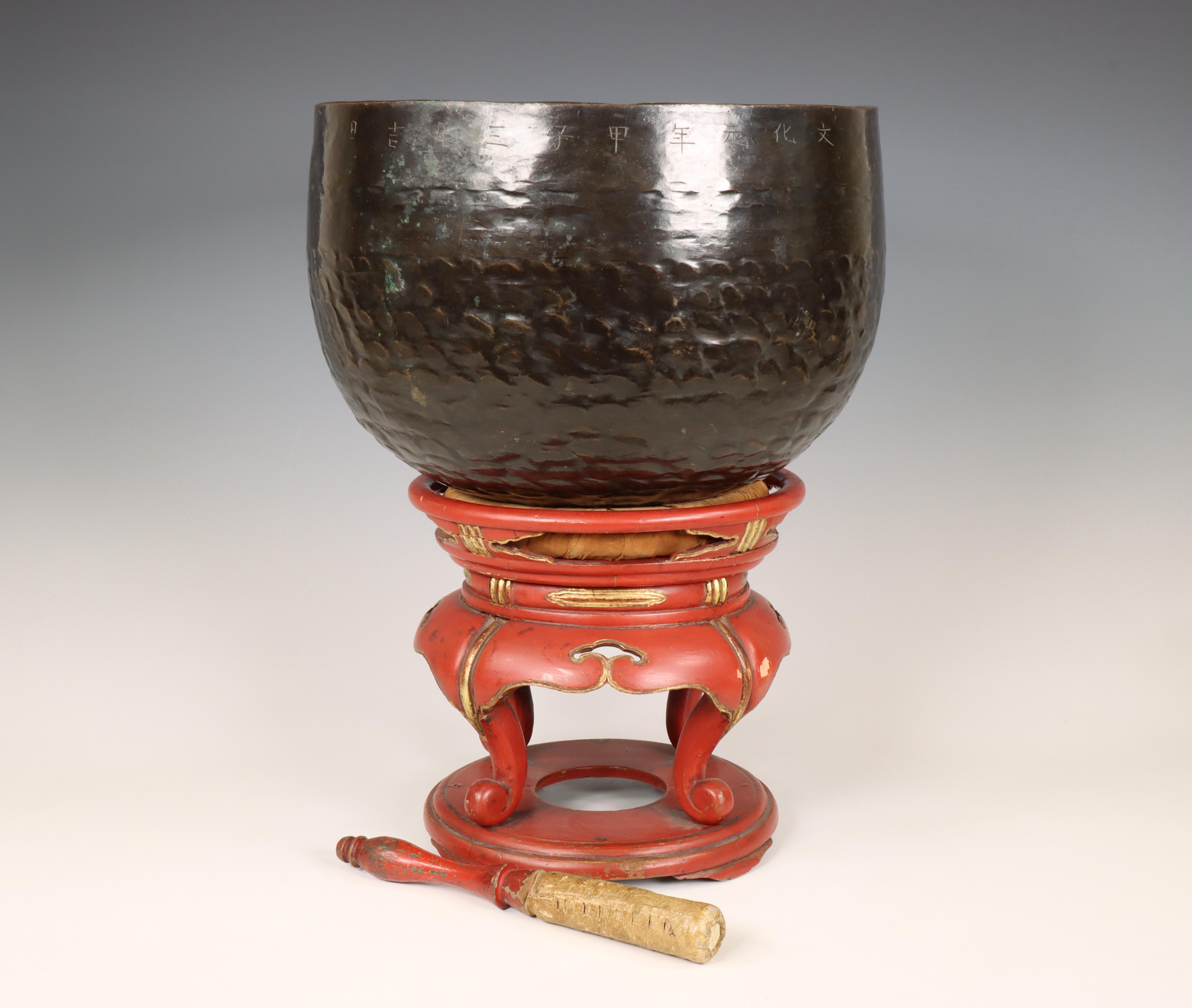 Japan, a metal alloy temple bell on red lacquer stand, 20th century,