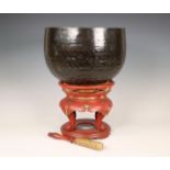 Japan, a metal alloy temple bell on red lacquer stand, 20th century,