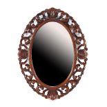 Oval mirror in wooden paneled frame