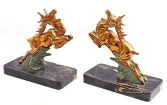 2 statues of deer