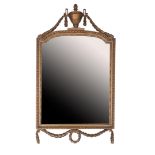 Facet cut mirror in richly decorated gold-colored frame