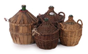 Lot glass wine bottles in wicker baskets