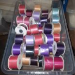 SEE IMAGE. LARGE QUANTITY OF VARIOUS RIBBONS IN VARIOUS COLOURS, THE CRATE IS NOT INCLUIDED -