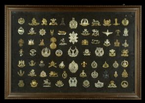 Miscellaneous Cap Badges. A framed collection of military cap badges including 11th Hussars...