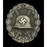 A M.1936 Spanish Civil War Wound Badge in Silver. Hollow back type, with round pin. Some ta...