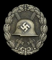 A M.1936 Spanish Civil War Wound Badge in Silver. Hollow back type, with round pin. Some ta...