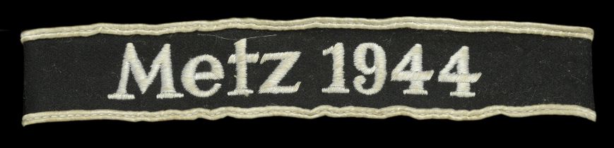 A rare 'Metz 1944' Cuffband. Black felt with white cotton borders, and white cotton machine...