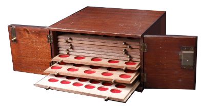 A wooden coin cabinet, 30 x 29 x 17cm, containing 10 trays (4 missing) single-pierced to hou...