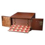 A wooden coin cabinet by St Leonards, 29 x 29.5 x 17cm, comprising 14 trays single-pierced t...