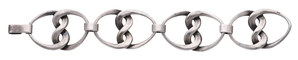 A French silver bracelet by Copin, circa 1970, the openwork links interlocking to form the s...