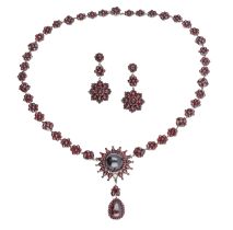 A late 19th century garnet necklace and earrings, the necklace designed as a series of rose-...