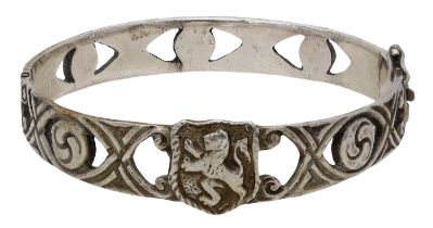 A silver bangle by Robert Allison, 1948, the hinged bangle centred with the 'Lion Rampant' o...