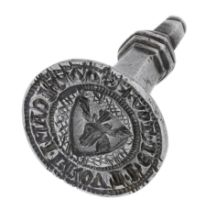 An early 14th century silver circular seal matrix, the hexagonal shaft surmounted by a trefo...
