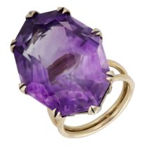 An amethyst dress ring, the large octagonal mixed-cut amethyst claw-set to a bifurcated band...