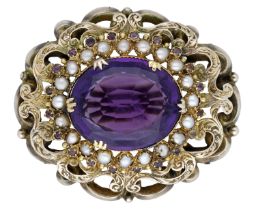 A late 19th century amethyst brooch, the oval mixed-cut amethyst set within a surround of se...