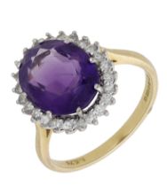 An 18ct gold amethyst and diamond cluster ring, 1986, the oval-cut amethyst within a surroun...