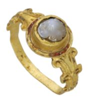 A 16th century Elizabethan gold ring set, the circular bezel set with a high relief white...