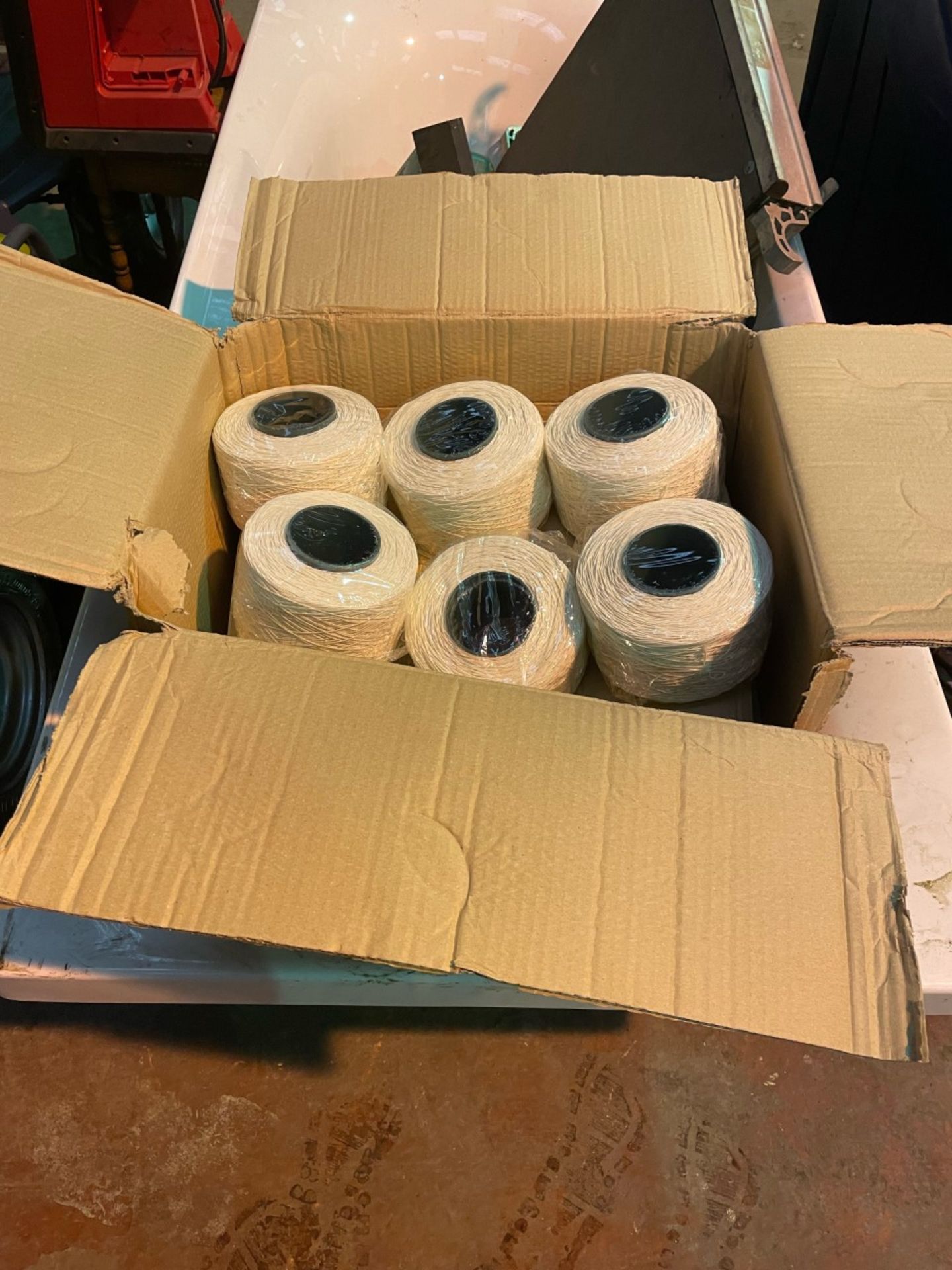 1 new box of white string rolls. 12 rolls in total