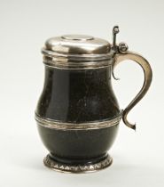 A SILVER MOUNTED HARD STONE TANKARD The lid engraved with an armorial and