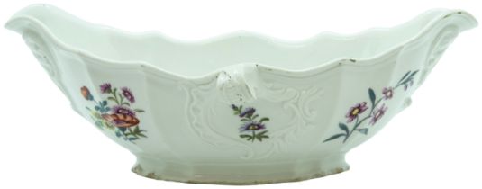 A FURSTENBERG PORCELAIN SAUCE BOAT CIRCA 1770 |The moulded body decorated with cut flowers, 23cms