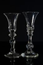 TWO SIMILAR WINE GLASSES MID 18TH  CENTURY The bell shaped bowls raised on knopped stems, tallest is