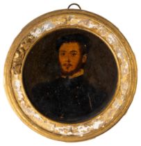 A SMALL OIL PORTRAIT ON CIRCULAR PANEL OF A 16TH CENTURY GENTLEMAN, the reverse of the panel with