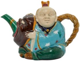 A MINTON MAJOLICA TEAPOT CIRCA 1876 Modeled as a Japanese actor holding a mask, date code for