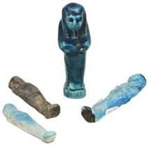 AN ANCIENT EGYPTIAN DARK TURQUOISE FAIENCE USHABTI and three other Ushabti figures. 10cms max