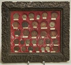 A BARBADOS GIII PENNY TOKEN ‘I SERVE’ MOUNTED IN A FRAME with various other coins and tokens with