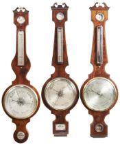 A GROUP OF THREE LARGE VICTORIAN MAHOGANY WHEEL BAROMETERS 19TH CENTURY two with signed dials, W.