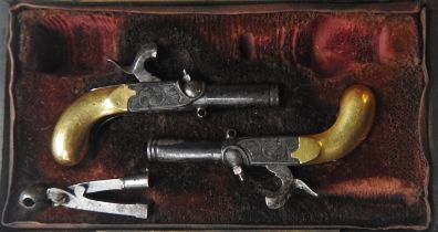 A CASED 19TH CENTURY PAIR OF MINIATURE PERCUSSION PISTOLS with engraved decoration, drop down