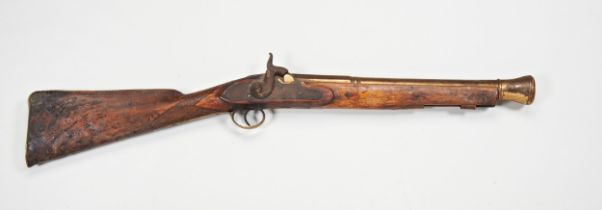 A 19TH CENTURY BRASS BARRELLED BLUNDERBUSS,  converted and in poor condition and a Tower flintlock