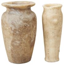 AN ANCIENT EGYPIAN ALABASTER JAR OF ELONGATED TAPERING FORM WITH TWO 'LUGS'. The flared rim partly