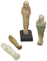 AN ANCIENT EGYPTIAN USHABTI FIGURE. (worn) on a wooden base and three other Ushabti figures. 12cms