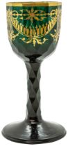 A GREEN GLASS WITH GILDED DECORATION 18TH CENTURY Decorated with gilded sways, raised on a faceted