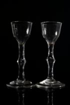 A PAIR OF FACETTED STEMMED WINE GLASSES MID 18TH CENTURY 14.5cms high