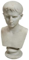 A MARBLE BUST OF THE YOUNG AUGUSTUS CAESAR. After the antique, unsigned and upon a socle base. 38cms