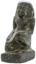 AN EGYPTIAN GRANITE FIGURE OF A KNEELING MAN, after the antique. 25 cms high