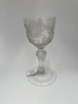 AN ENGRAVED 18TH CENTURY WINE GLASS Circa 1750, the engraved bowl raised on a faceted stem, 19cms