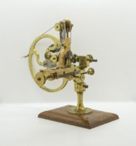 AN ANTIQUE WATCHMAKERS LATHE,19th century, in brass and steel on a mahogany base. 16 x 28 cms