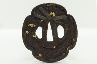 A JAPANESE IRON TSUBA beautifully decorated with butterfly in gold inlays and three other iron