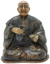 A JAPANESE POTTERY NODDING-HEAD FIGURE LATE EDO / EARLY MEIJI PERIOD  modelled as an elderly man