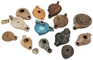 A ROMAN POTTERY OIL LAMP CIRCA 2nd CENTURY. and various other oil lamps, mostly ancient but with