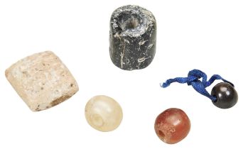 A SMALL CUNEIFORM TABLET. A cylinder seal, an ancient haemetite seal and two other seals