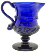 A 'BRISTOL' BLUE JUG 18th century, raised on a foot, 12cms high