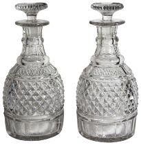 A pair of cut glass decanters & stoppers. (H: 25cm)
