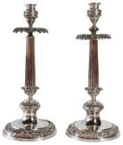 A pair of German silver candlesticks of tapered form upon circular scrolled bases. (H: 34cm), 981