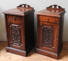 A PAIR OF MAHOGANY BEDSIDE CUPBOARDS, 20TH CENTURY, frieze drawer over a panelled cupboard door,