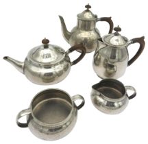 A LIBERTY FIVE PEWTER TEA SET with hammered finish marked 'Made by Liberty & Co English Pewter'.