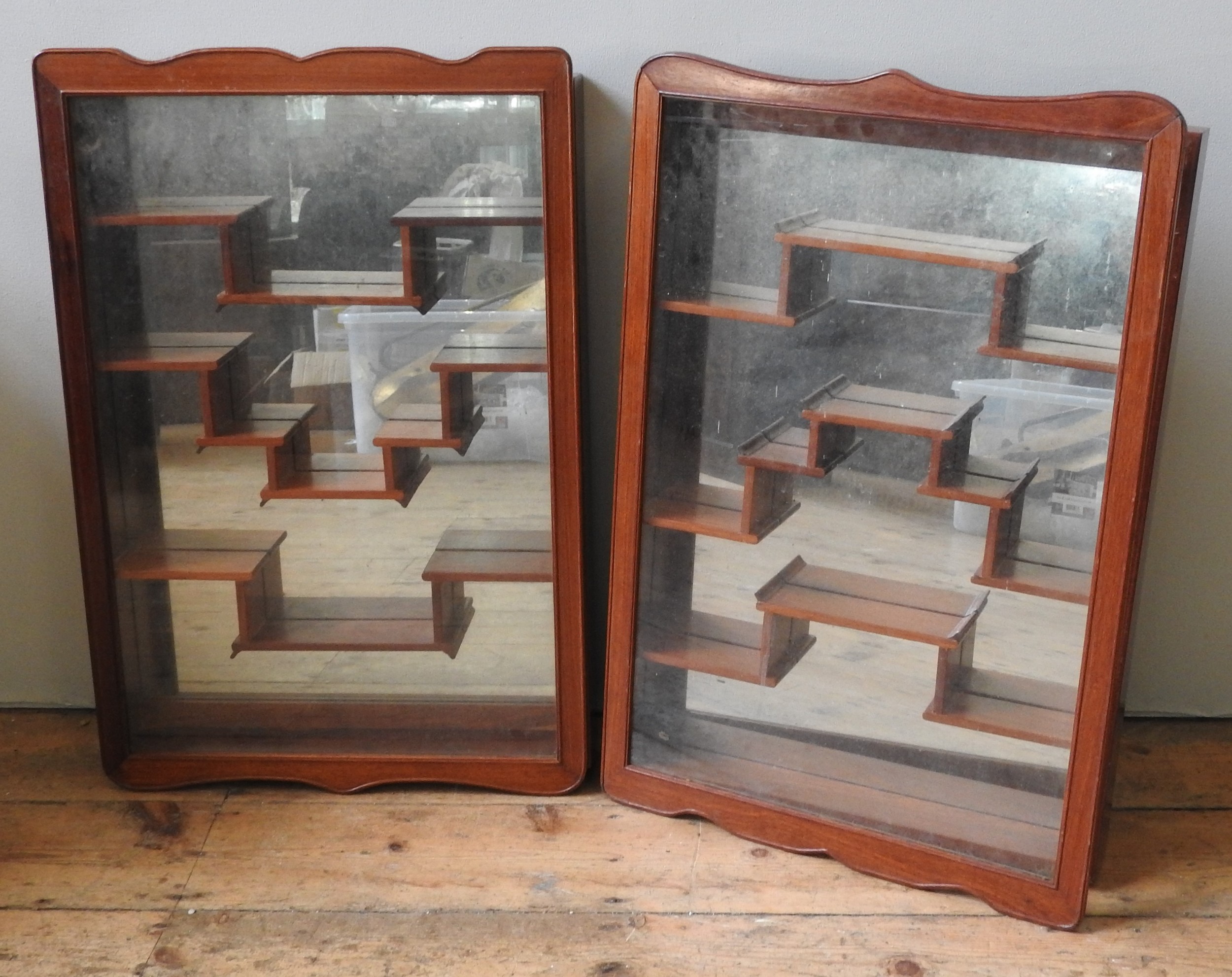 A PAIR OF CHINESE HARDWOOD WALL CABINETS, 20TH CENTURY, rectangular form, the glazed undulating edge